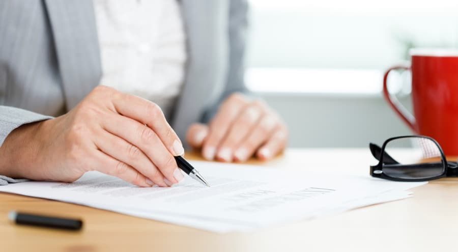 Close-up shot of businesswoman filling out forms.