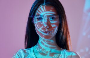 Young woman is in projector neon lights in the studio