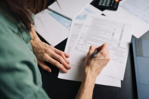 Woman filling out tax form.