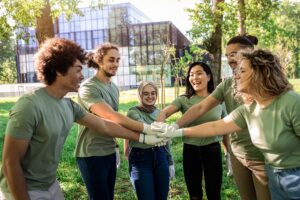 Portrait of multiethnic group of volunteers with garbage bags cleaning city park.