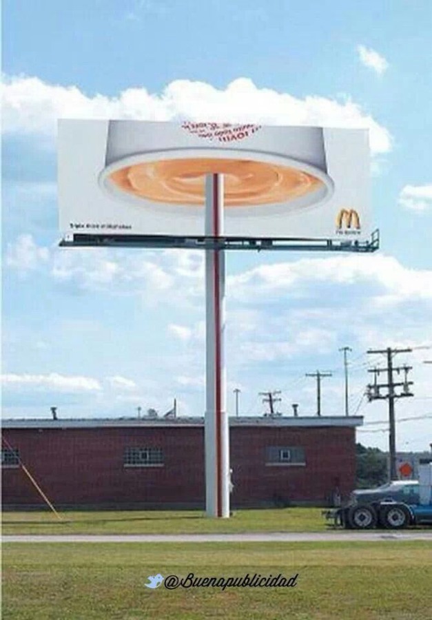 A billboard ad from McDonald's incorporating the billboard pole as a straw to an upside-down drink.