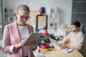 Young businesswoman scrolling in tablet while searching online.