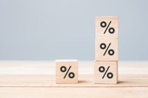 Four wooden blocks with percentage symbol icon.