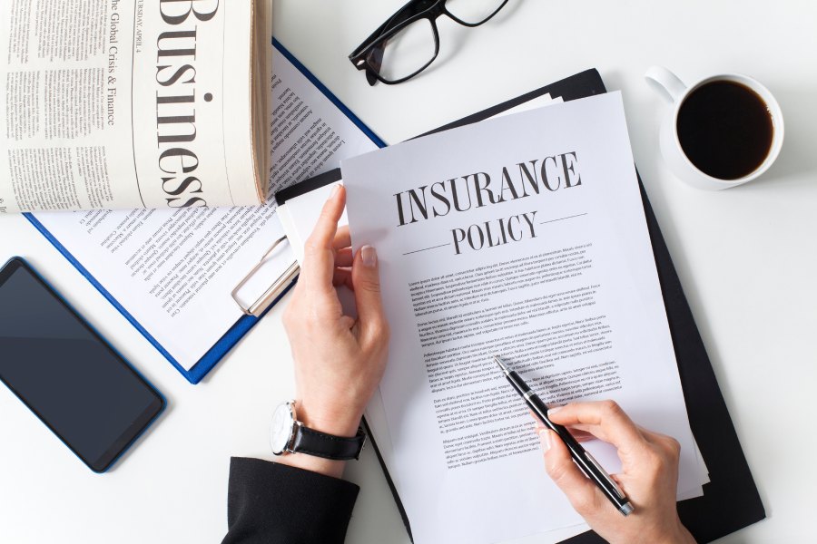 Businessman examining insurance policy.