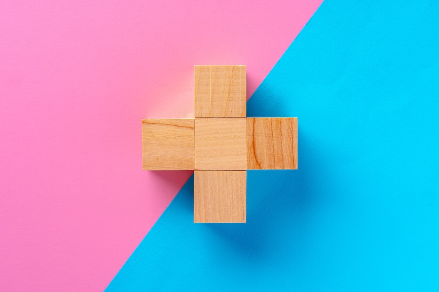 Top view photo of wooden blocks on pink and blue