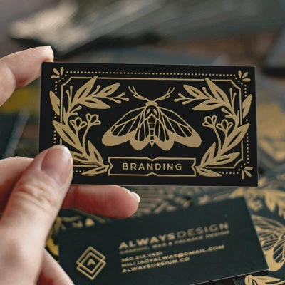 A business card printed by MOO with gold foil finish.