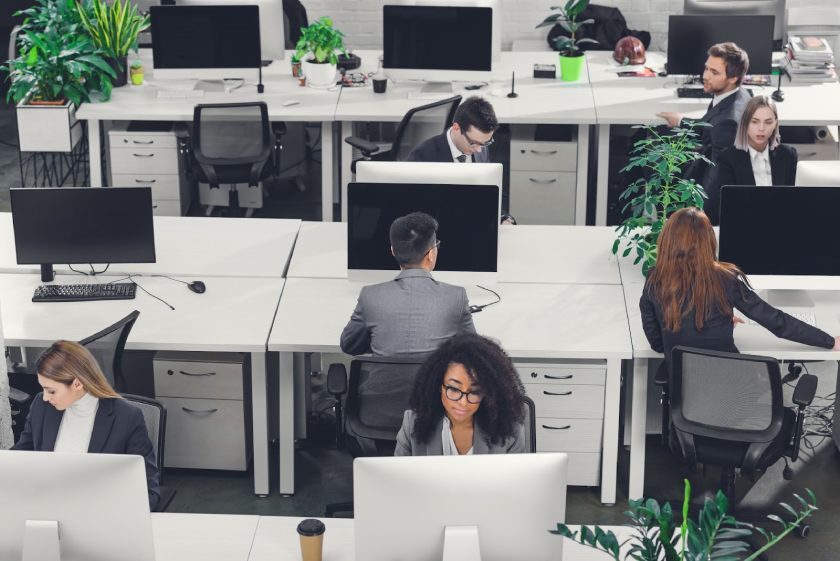 High-angle view of employees working in an open space office.