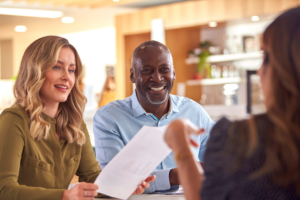 Group Of Business Colleagues Having Informal Meeting Around Table In Office Coffee Shop