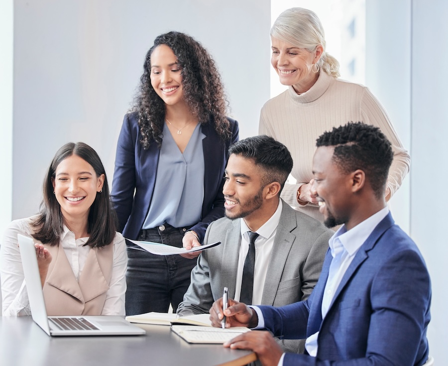 A group of businessepople using a laptop during a meeting.