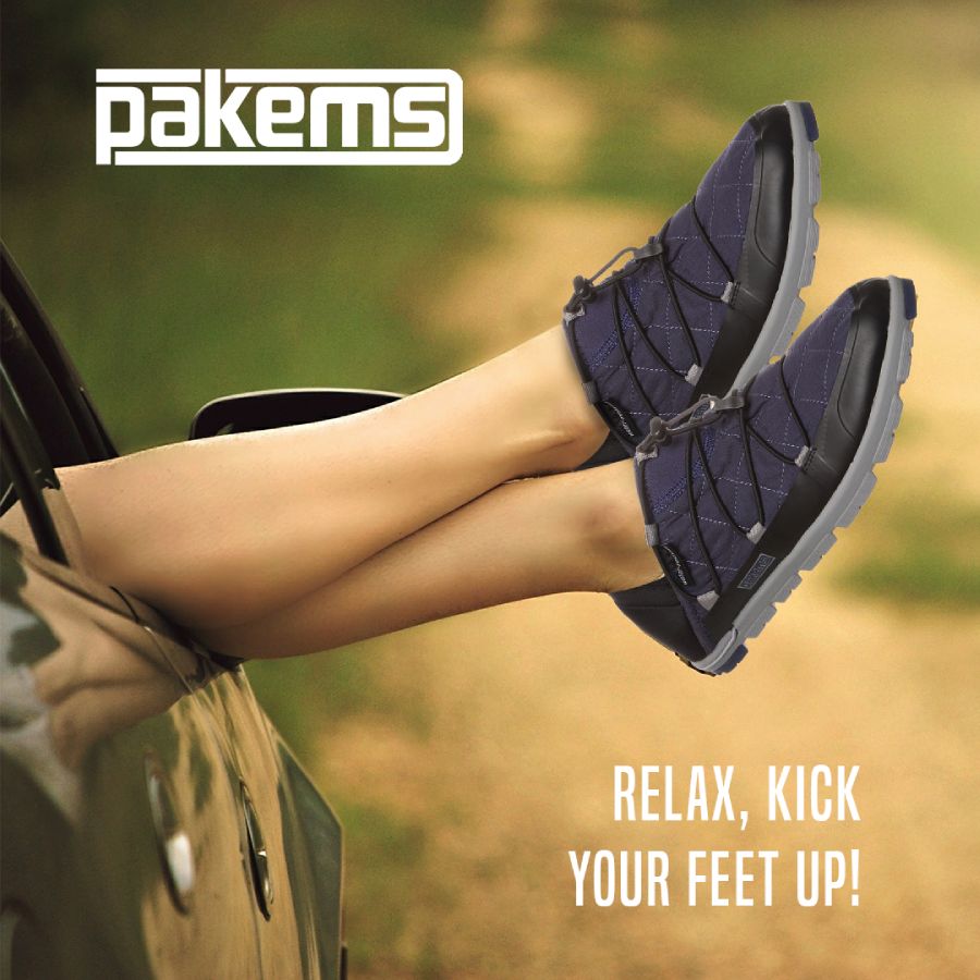 Social Marketing Ad for Pakems shoes depicting a woman's legs sticking out of a car window, clearly relaxing in the front seat. The headline is "Relax, kick your feet up!"