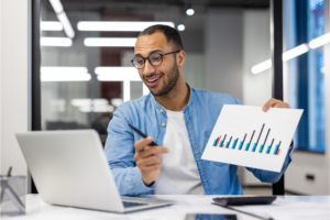 Confident Indian businessman presenting report in office