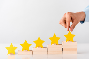 cropped view of man touching yellow star on white