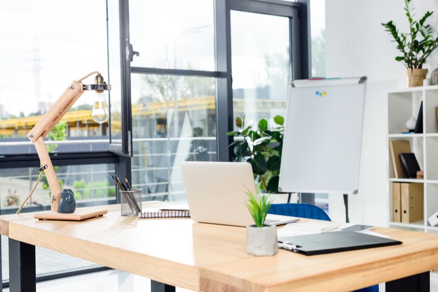 modern home office with laptop and stationary on table