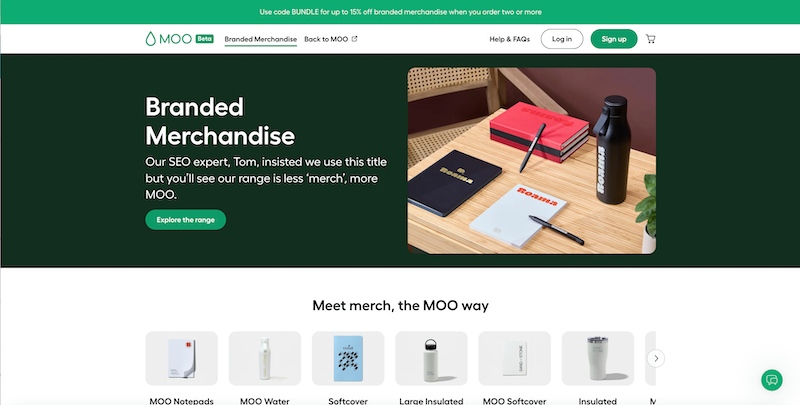 Moo’s branded merchandise page with the headline “Branded Merchandise” and the cheeky subhead: “Our SEO expert, Tom, insisted we use this title, but you'll see that our range is less merch and more Moo”. The hero image is a table with 3 notebook examples and a water bottle.