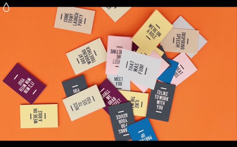 A scattering of business cards on an orange background, all in different solid colors with different phrases on them such as: “It’s win, win with you!”, “I’d like to work with you.” and “Inspiring Speech!”