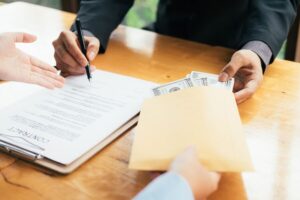 man giving documents to other person