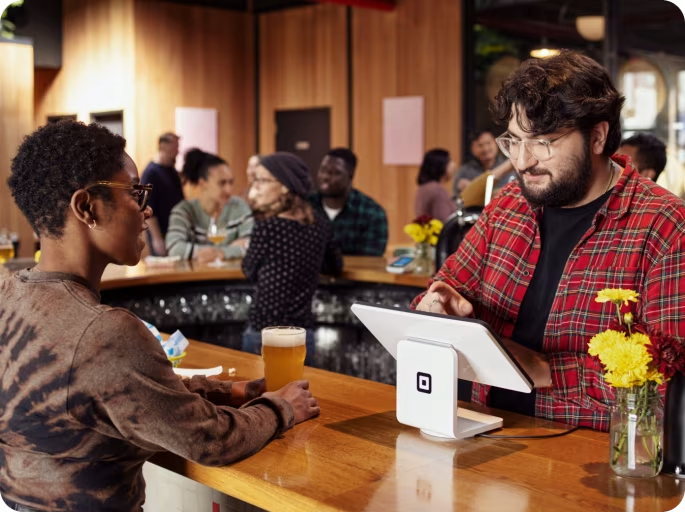 Square’s sleek terminal stand fits nicely into bar settings.