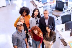 Diverse business team smiling while posing together in the office.