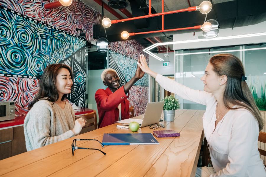 A coworking space with colleagues celebrating success.