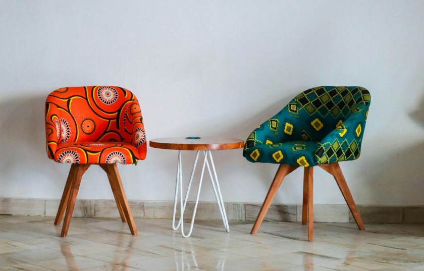 Two Assorted-color Padded Chairs Near Side Table.