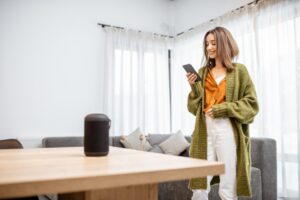 Woman controlling home devices with a voice commands.