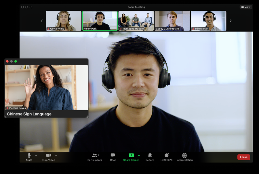 A Zoom meeting interface with a dedicated video channel for a sign language interpreter.