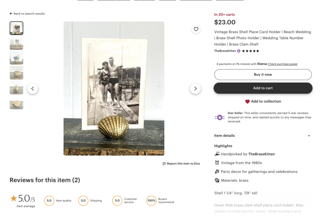 Vintage brass shell place card holder holding a black-and-white photo, an example of collectible vintage home decor sold on Etsy.