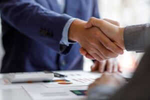 2 Businessmen shaking hands.