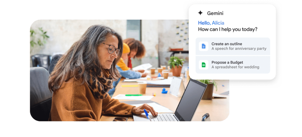 Coworkers working at a shared desk overlaid with a Google Gemini prompt to assist with creating an outline document or budget proposal.