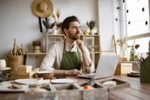 A business owner working on his office in front of laptop.