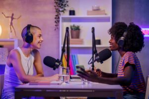 women happily talking sitting in a home broadcasting studio