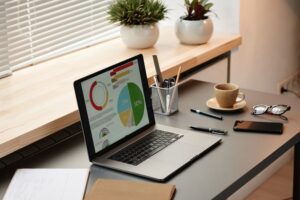 Examining financial graphs on laptop