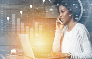 A remote worker using a business phone plan on a smartphone and laptop with a digital data overlay for 2026 business communication.
