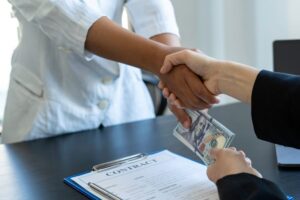 a person handing a money to another person