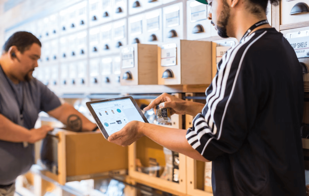 A retail employee uses a tablet to track inventory and manage stock levels in real time.