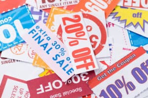 Colorful pile of discount and sale flyers.