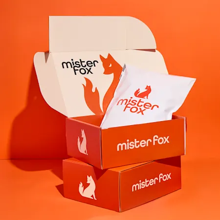 Branded ecommerce packaging with custom boxes, tissue paper, and logo design for small business marketing.