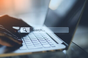 A man searching on a laptop.